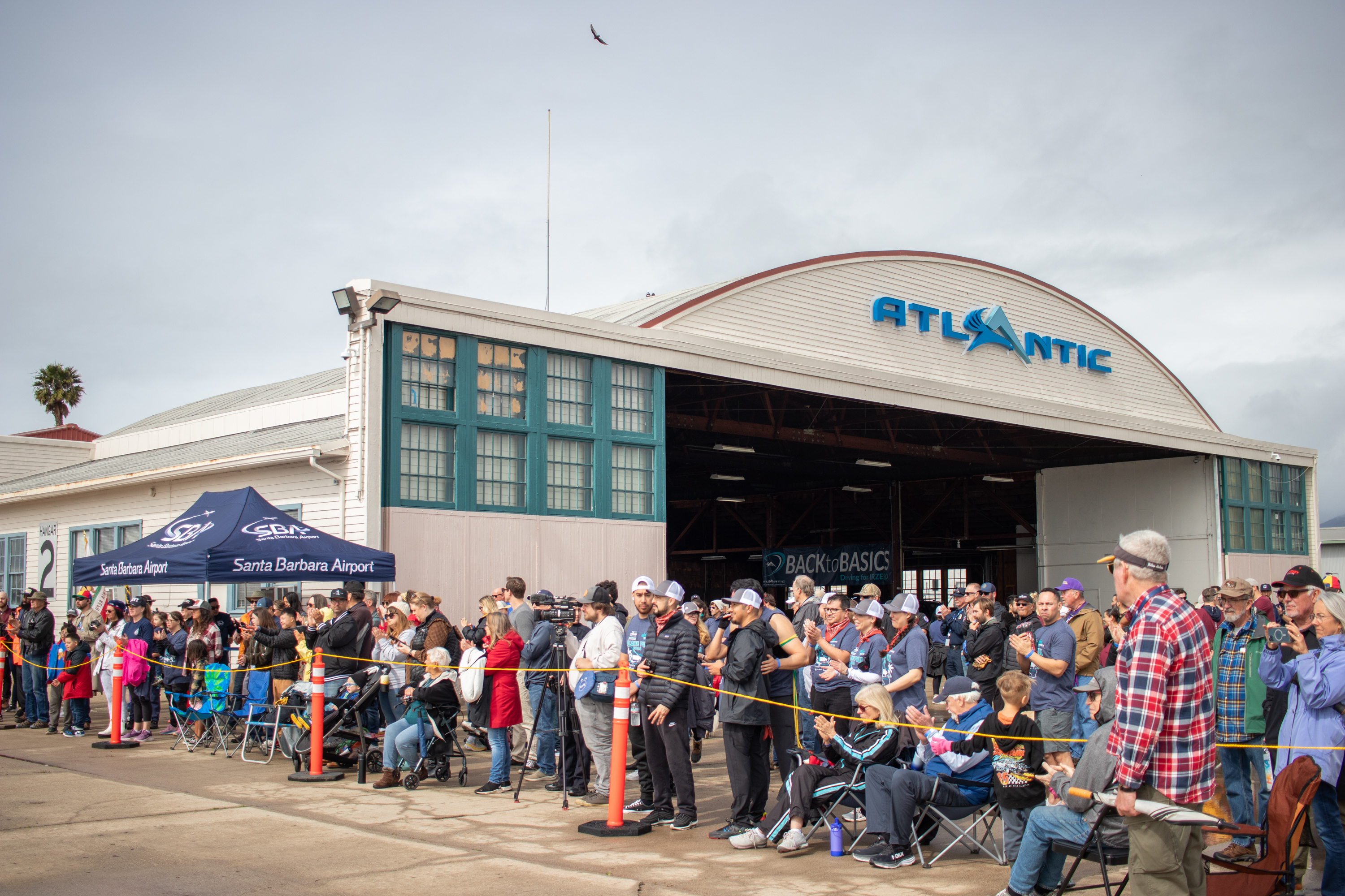 A crowd watches the Plane Pull at an Atlantic Aviation hangar.