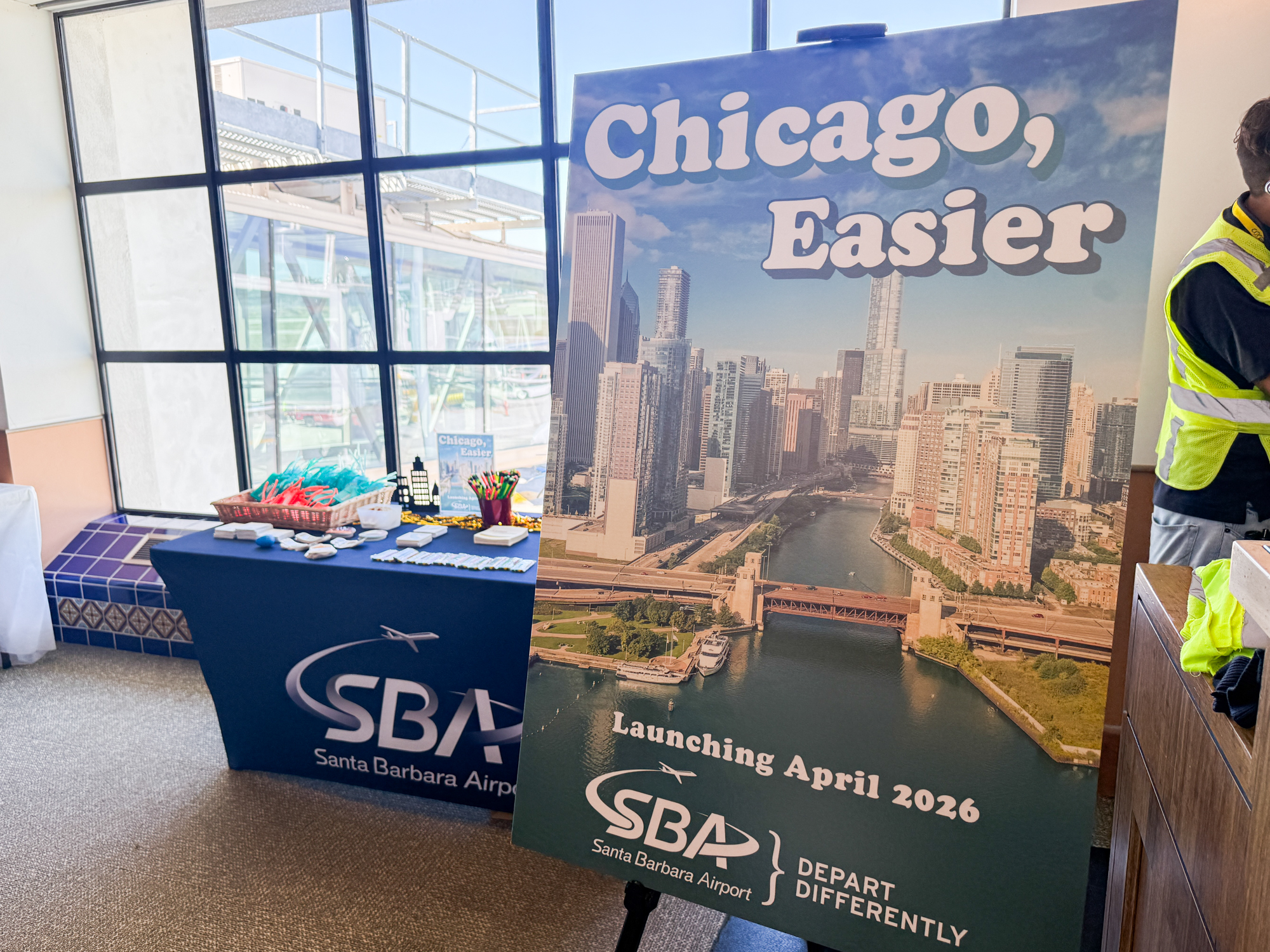 A large poster reads "Chicago, Easier" in front of a table with SBA swag.