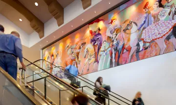 Escalators with colorful pictures of women dancing