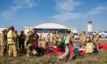 First responders and role-playing emergency "victim" volunteers participate in a live disaster drill 