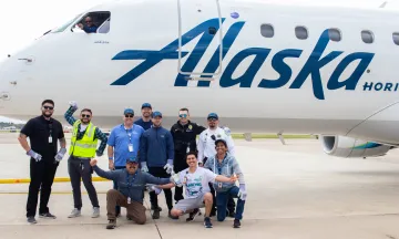 SBA Team poses in front of Alaska Airlines plane
