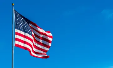 American Flag flowing against a blue sky