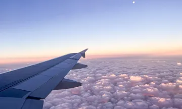 View of the sky overlooking airplane wingtip 