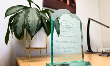 A glass plaque says "Santa Barbara Airport Community Impact Award"