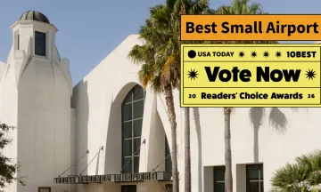 Front entrance of the terminal with text that says vote now best small airport