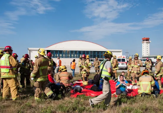 First responders and role-playing emergency "victim" volunteers participate in a live disaster drill