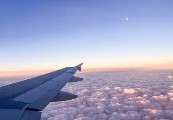 View of the sky overlooking airplane wingtip 