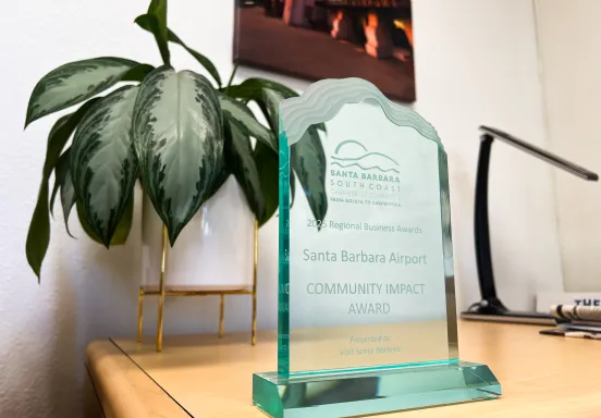 A glass plaque says "Santa Barbara Airport Community Impact Award"