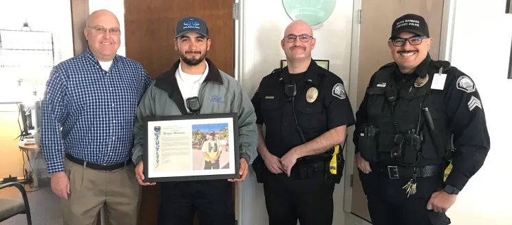 Airport staff presenting employee of the month plaque 