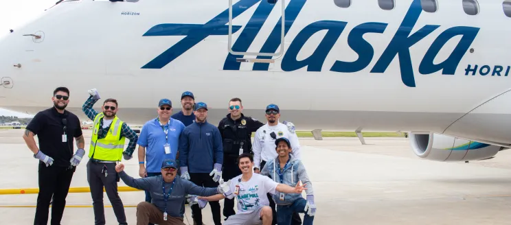 SBA Team poses in front of Alaska Airlines plane