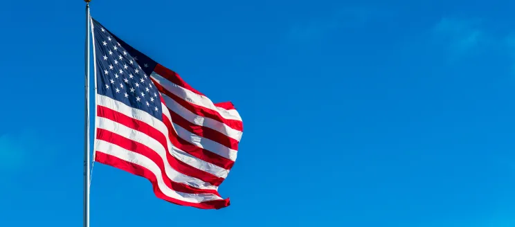 American Flag flowing against a blue sky