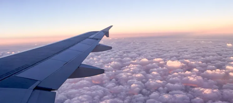 View of the sky overlooking airplane wingtip 