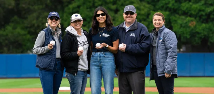 SBA staff pose with UCSB staff on a baseball field