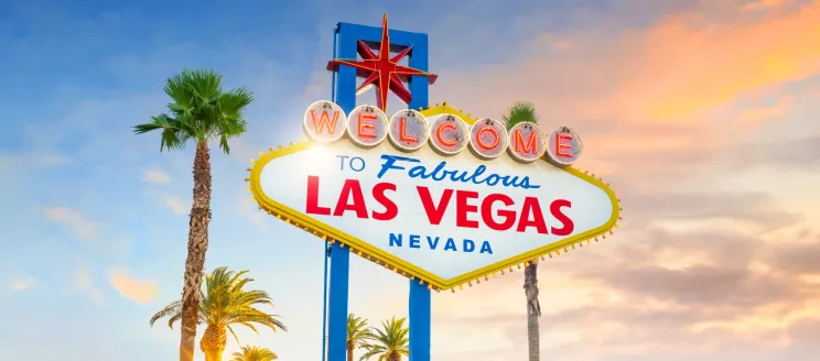 The famous sign that reads "welcome to fabulous Las Vegas, Nevada" against a sunset sky. 