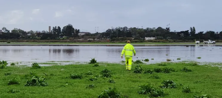 Worker on flooded airfield