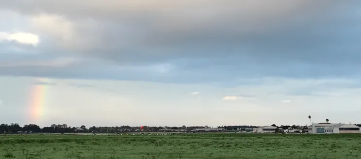 Rainbow above green field