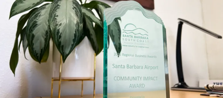 A glass plaque says "Santa Barbara Airport Community Impact Award"