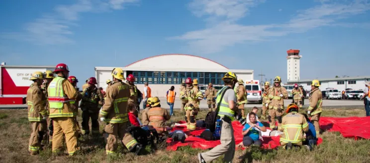 Firefighters aiding emergency drill volunteer "victims" during SBA emergency drill.