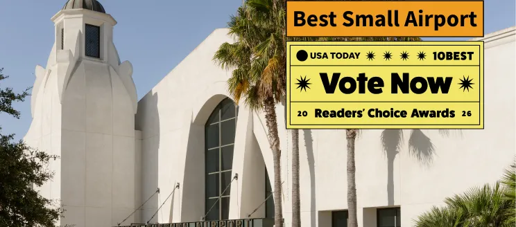 Front entrance of the terminal with text that says vote now best small airport
