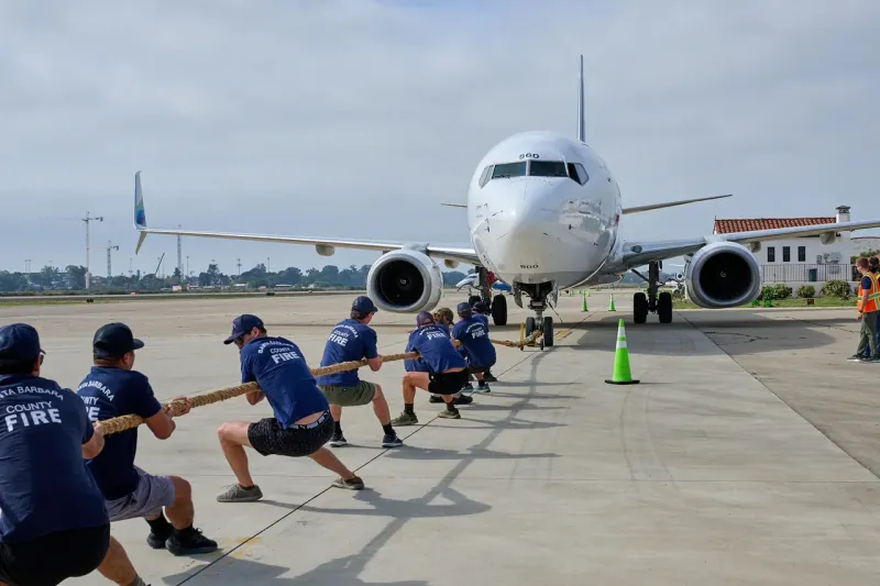 A team pulls an airplane at the 2025 plane pull