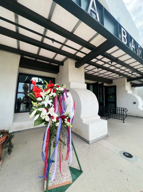 A memorial wreath sits outside the SBA Terminal