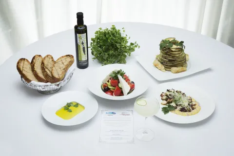 Photo of food spread on a while tablecloth 